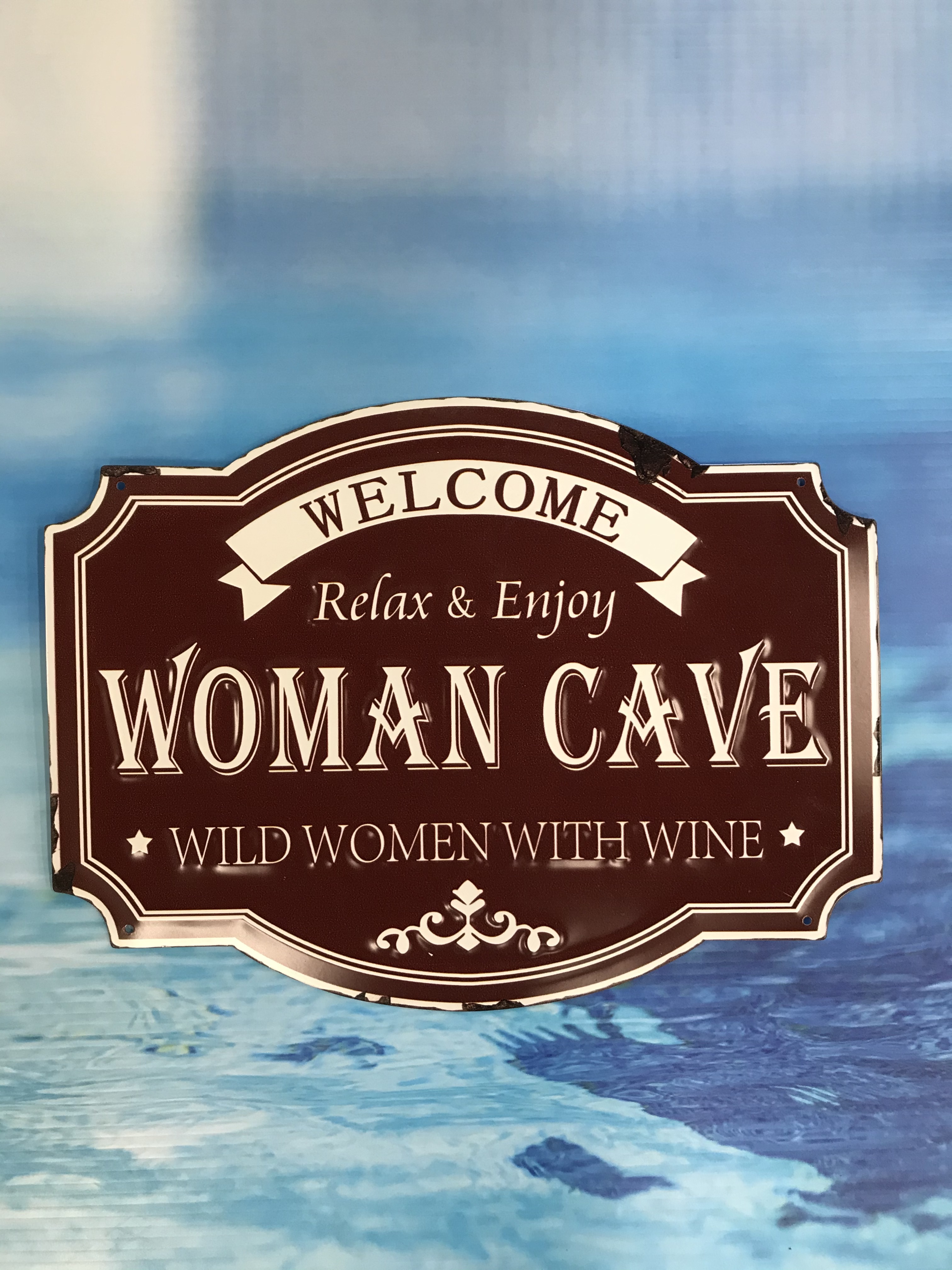 Woman Cave Embossed Metal Sign